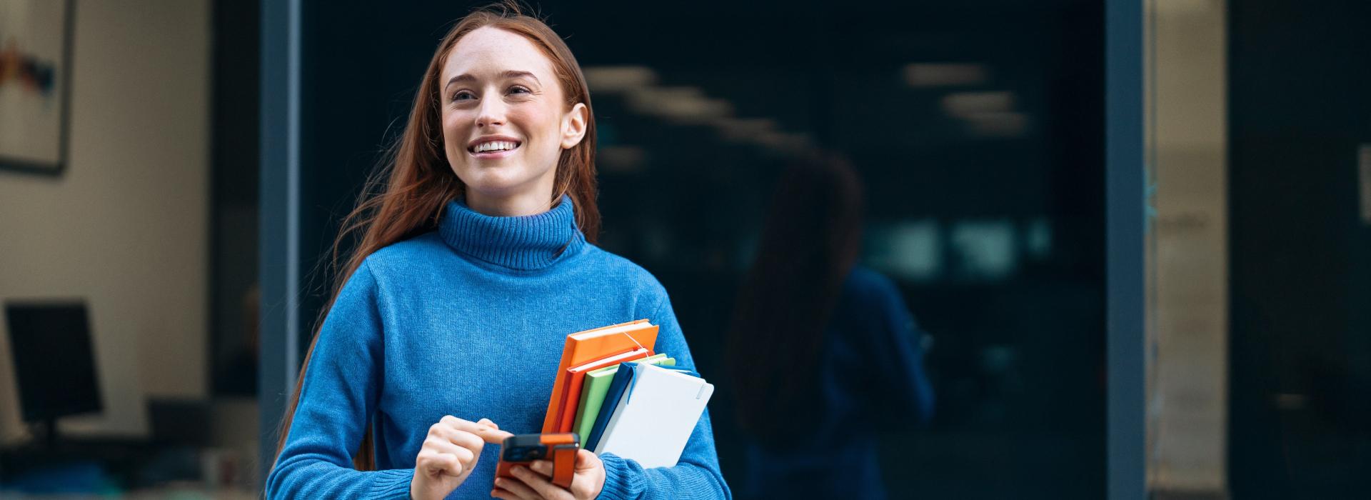 Smiling girl with books