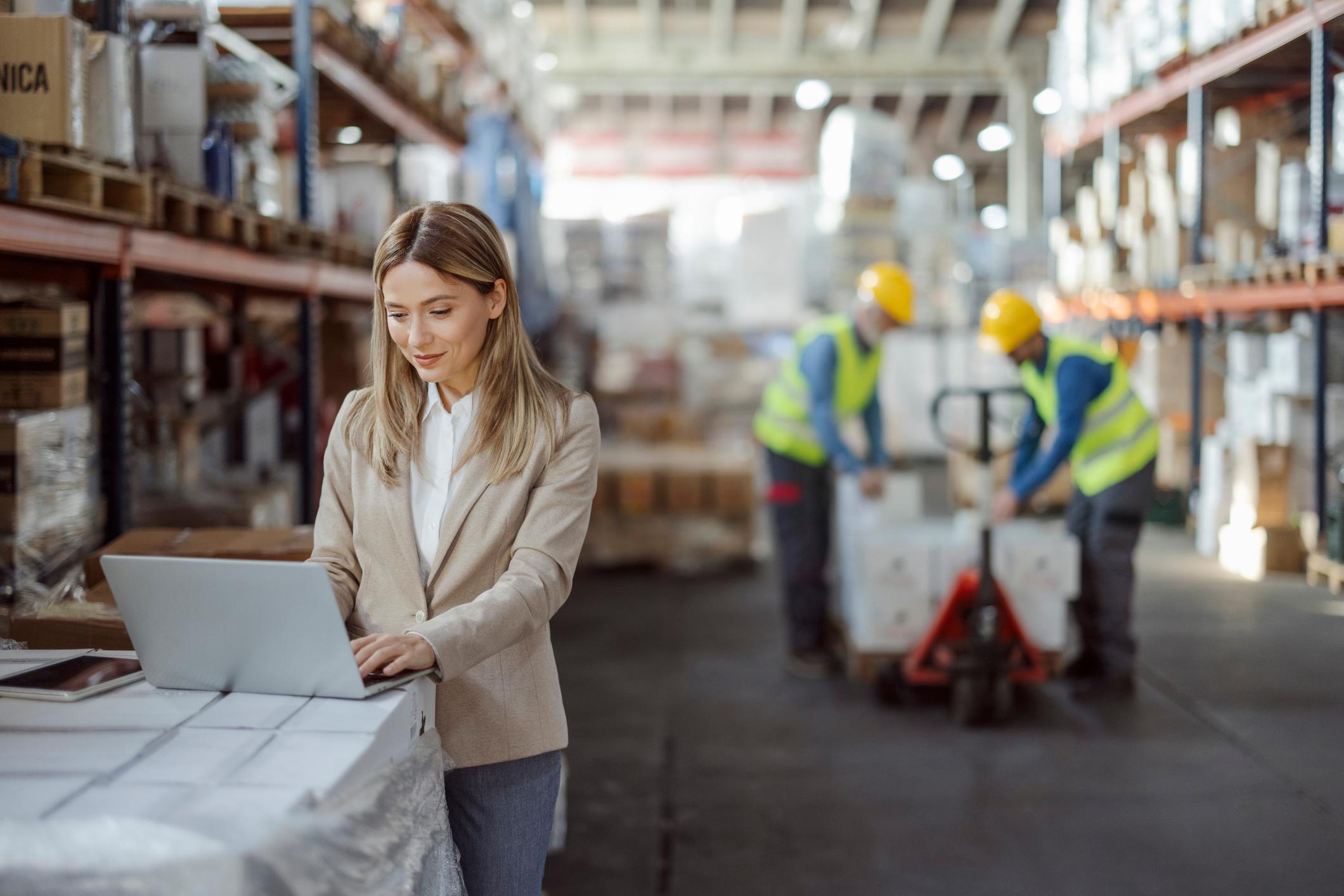 Warehouse manager working with laptop